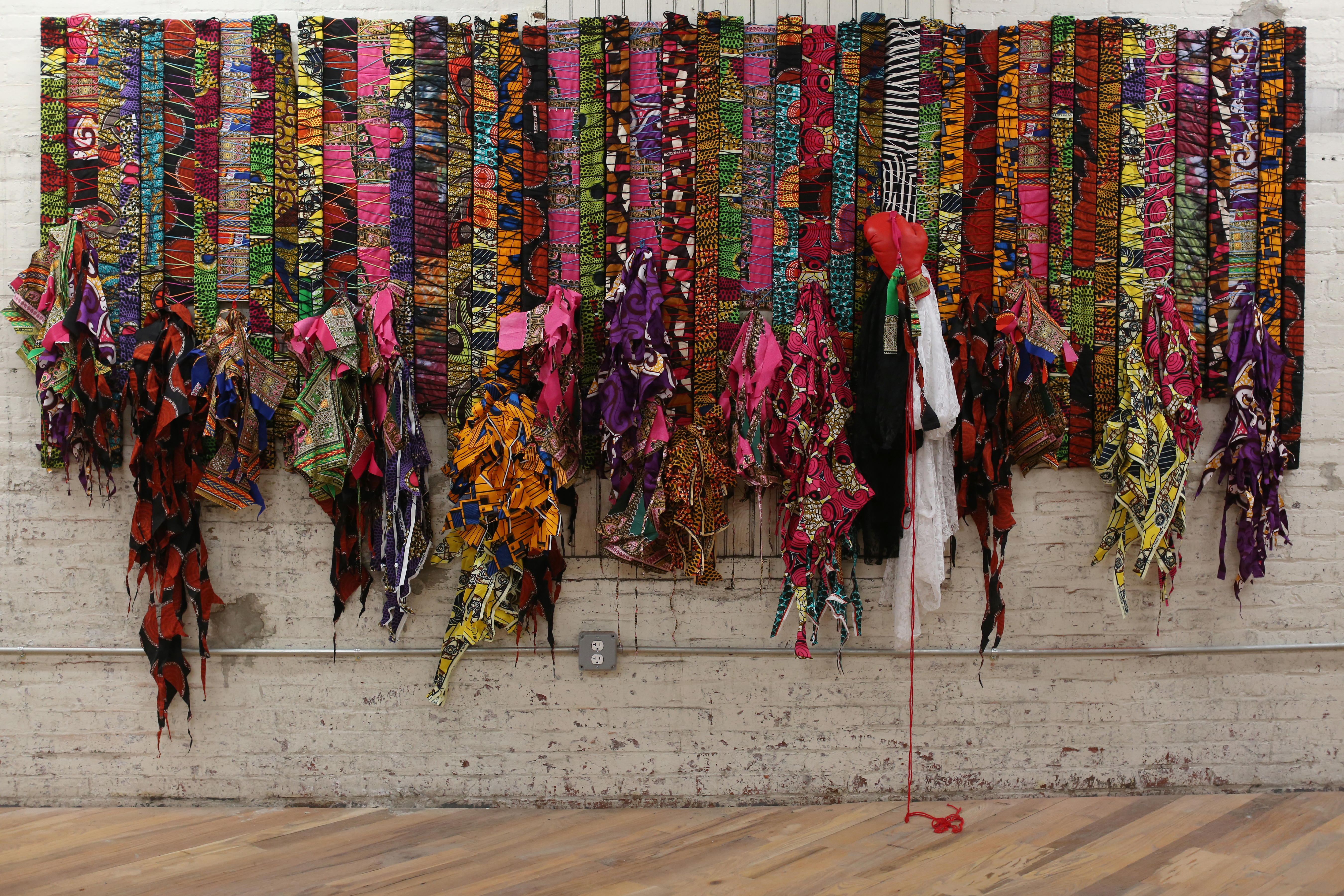 In an ArtPlace-funded residency, Nigerian artist Olanrewaju Tejuoso spent months at the Village of Arts and Humanities on projects helping residents remember and grieve loved ones who had died. Residents created this collective memorial using wax-print cloth with knots that represent memories and connections.