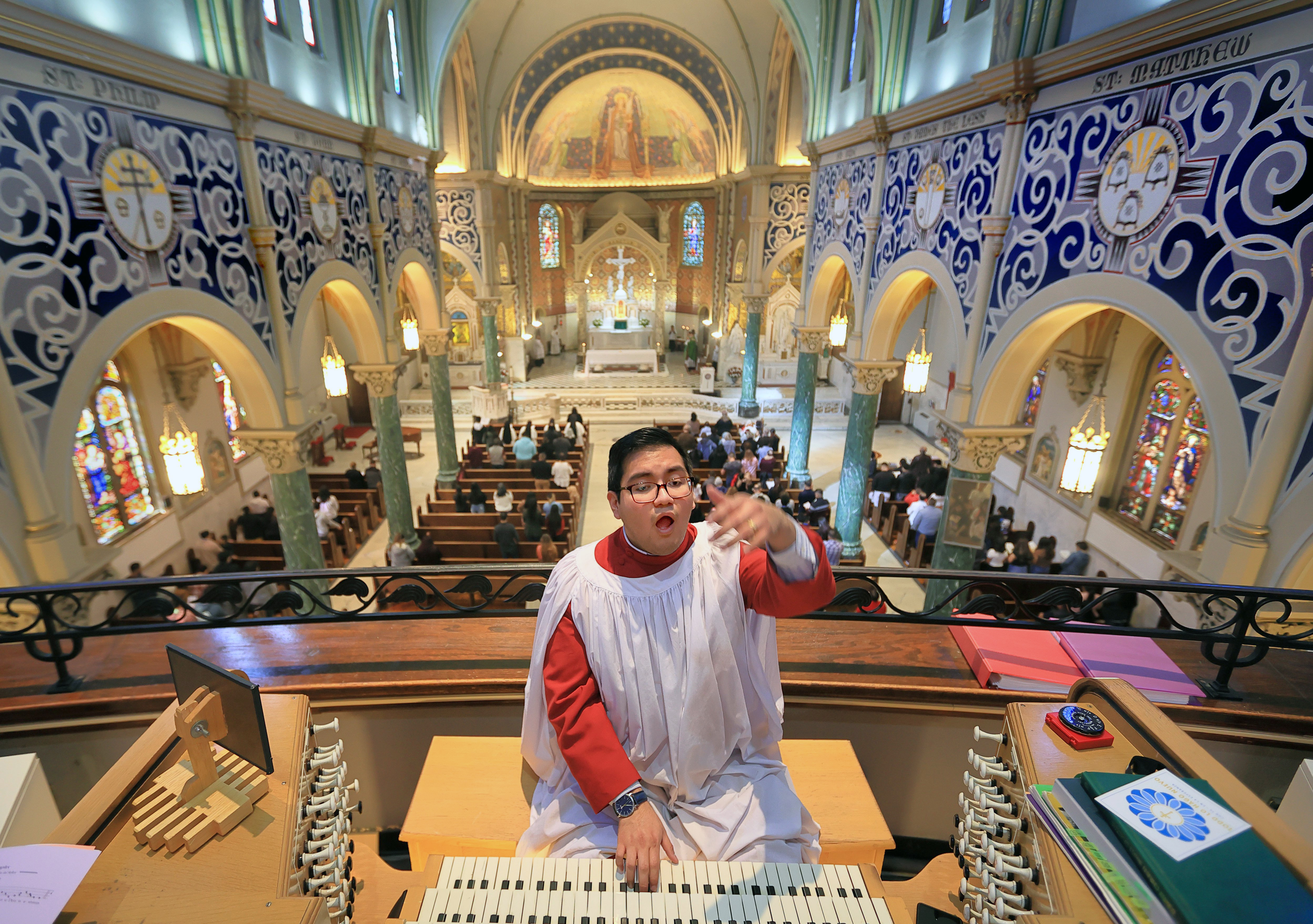 Carlos Flores Ramirez, director of sacred music at St. Cecilia Catholic Church, plays a hymn on the organ as he also directs the choir during a Sunday morning mass at the church on Sunday, Feb. 5, 2023.  
