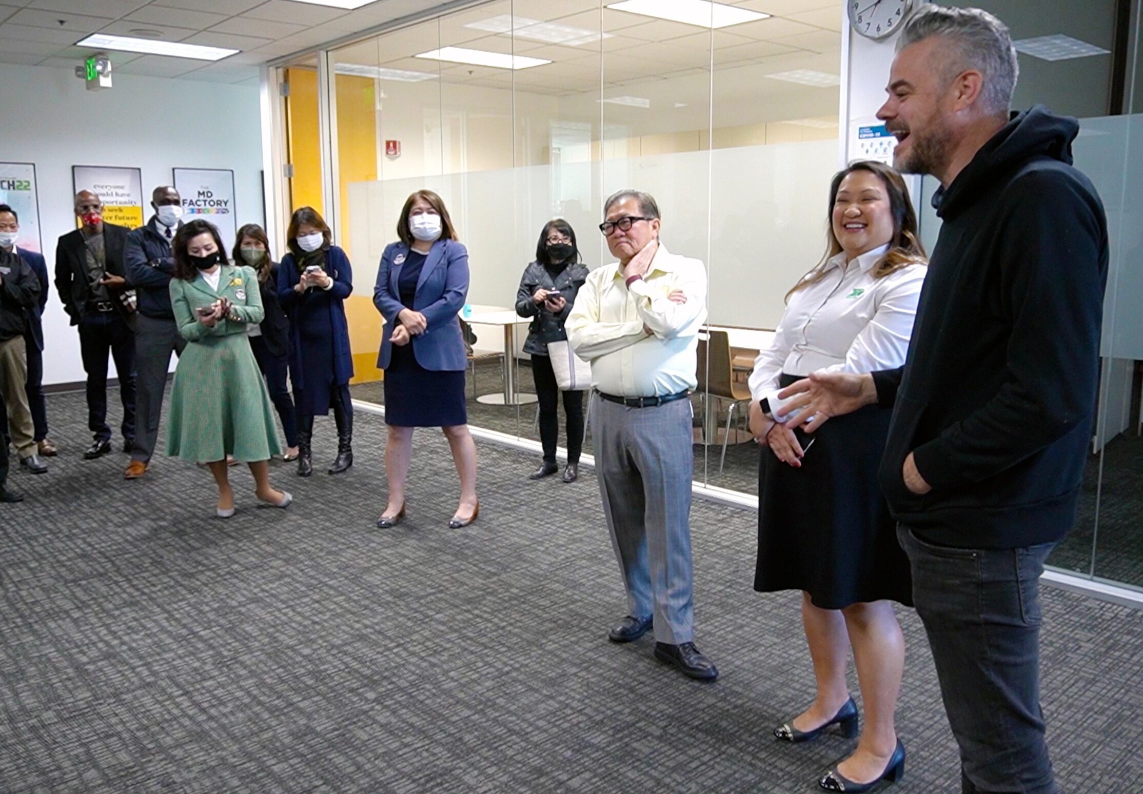 charity:water founder, Scott Harrison (right) speaks with employees of World System Builder during a visit to their offices in December 2021. To his right stands Alicia Nguyen, Executive Vice Chairman.