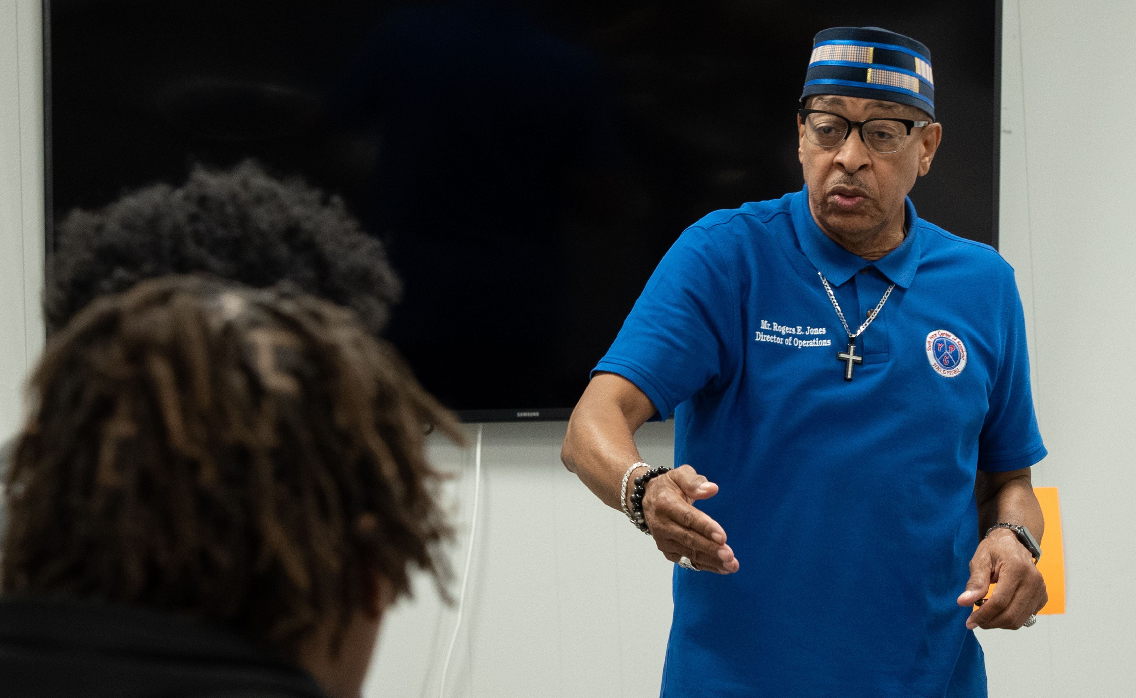 Rogers Jones, director of operations, exhorts a group of young men to become more involved at The Youth Peace Center of Roseland in Chicago, Thursday, Sep. 8, 2022.
