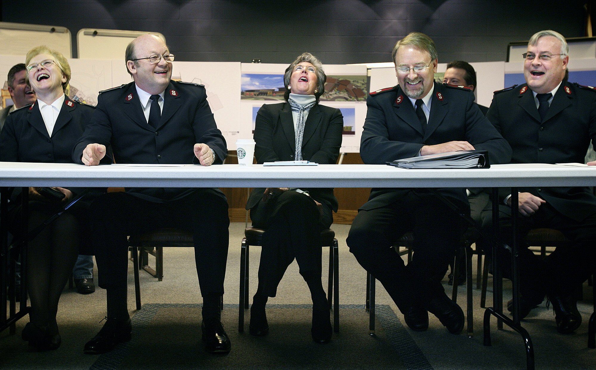 Coeur d’Alene Mayor Sandi Bloem, center, along with Lt. Col. Joann Brodin, left, Lt. Col. Harold Brodin, second from left, Maj. John Chamness, second from right, and Maj. Benton Markham, all from The Salvation Army, react Monday, May 1, 2006, moments before announcing Coeur d’Alene, Idaho was selected to receive funding for a new community center. This city was one of six in the West selected by the Salvation Army for a $65 million Ray and Joan Kroc Corps Community Center.