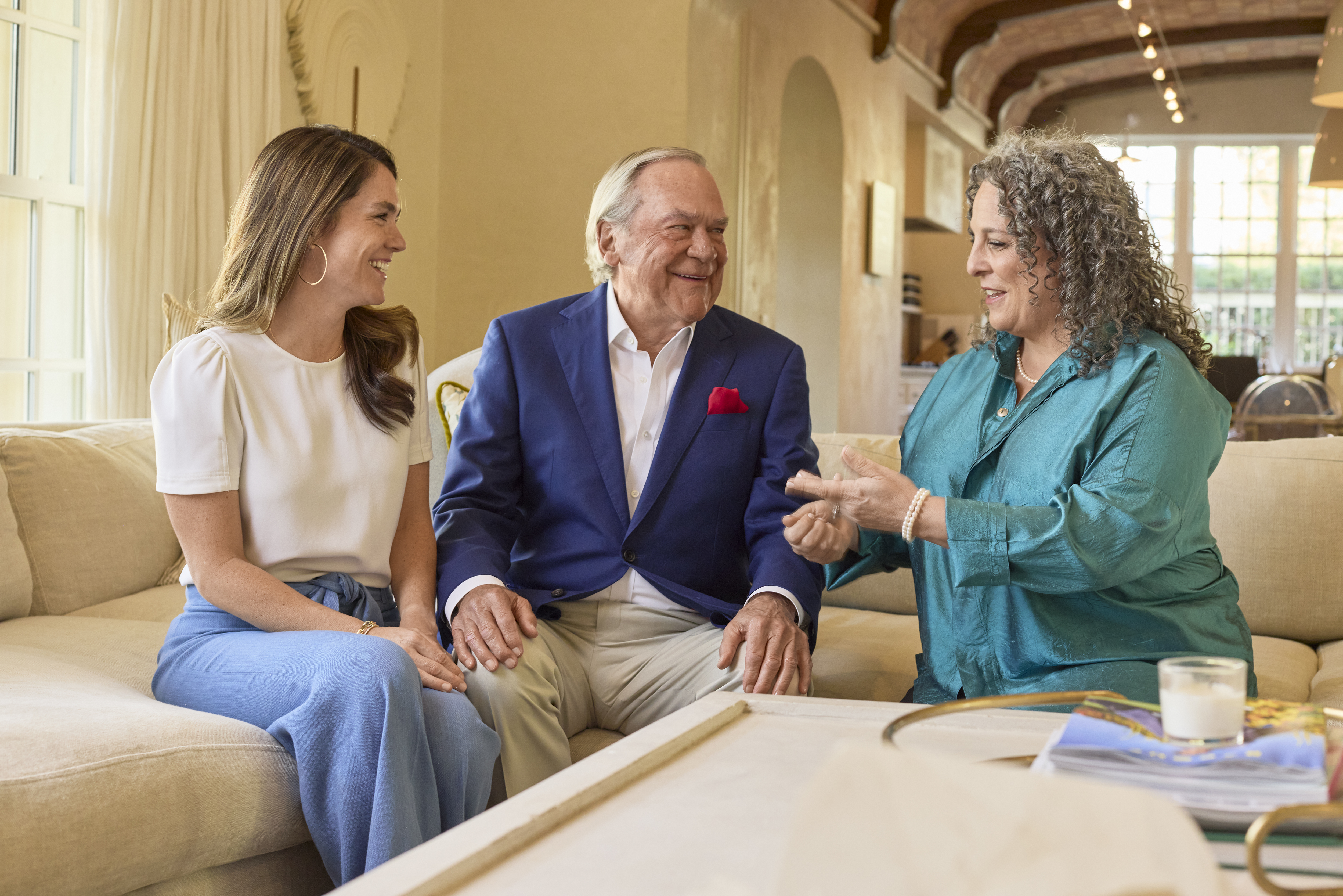 Peter J Fluor and his daughter Lacey Fluor Goossen sit with Jennifer Touchet