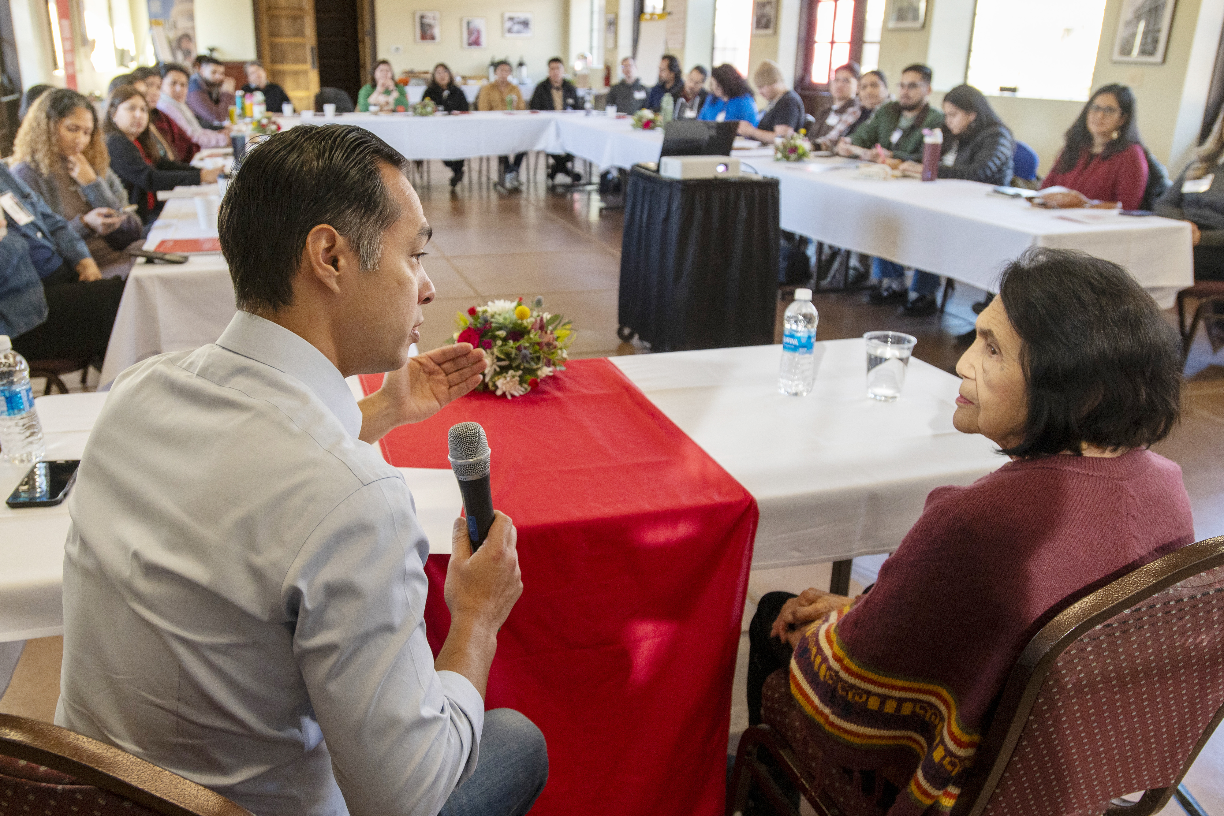 Julian Castro, left, CEO of the Latino Community Foundation, and Dolores Huerta, a leader and activist in the American labor movement who co-founded the group that became the United Farm Workers, sit in conversation with the cohort members in the foundation's third Latino Nonprofit Accelerator during a cohort retreat in Tehachapi, Calif., on Jan. 30, 2025.