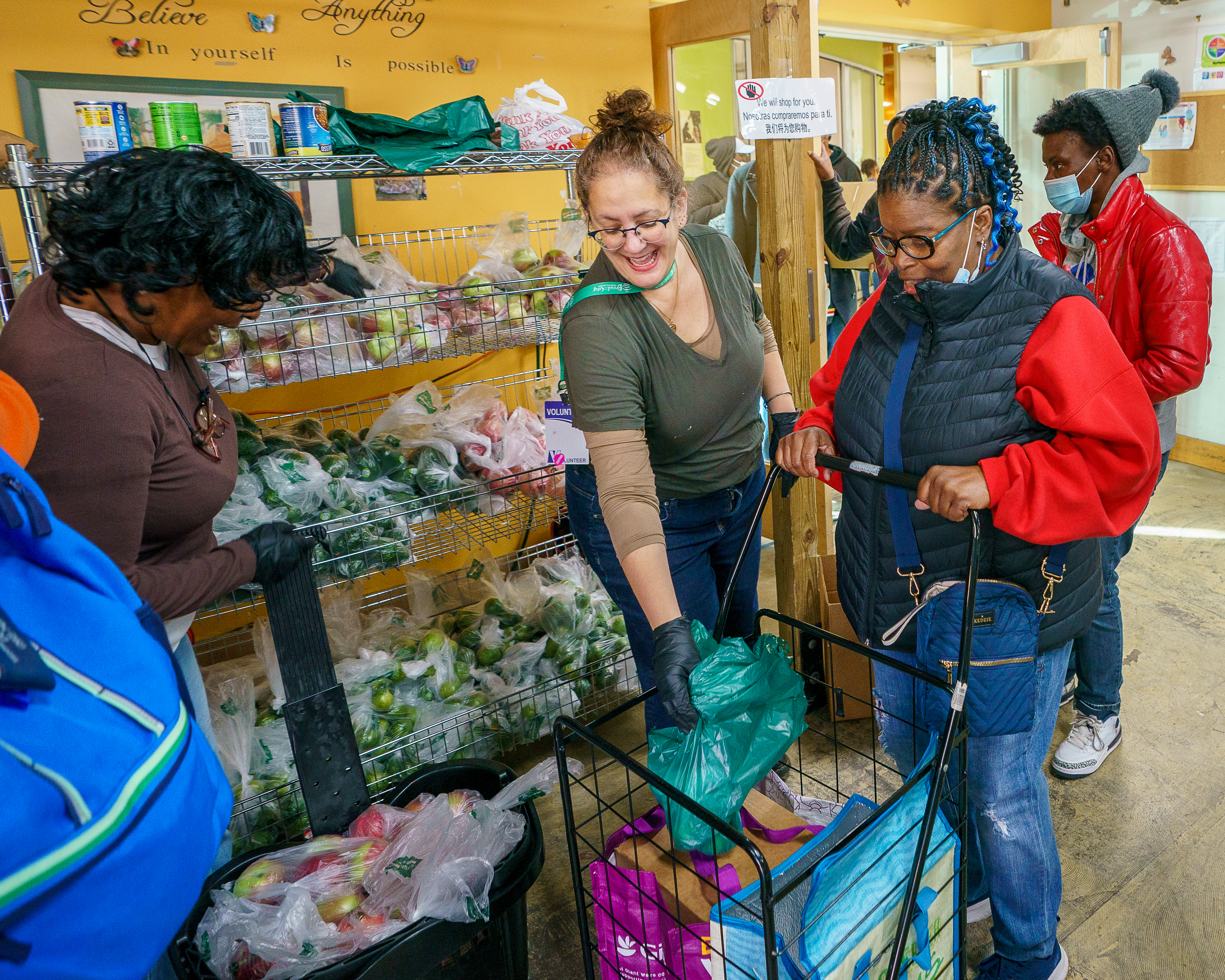 Volunteers help fill grocery carts during the opening of Bread for the City’s annual Holiday Helpings campaign, at 7th Street NW, in Washington, D.C., on Nov. 4, 2024.