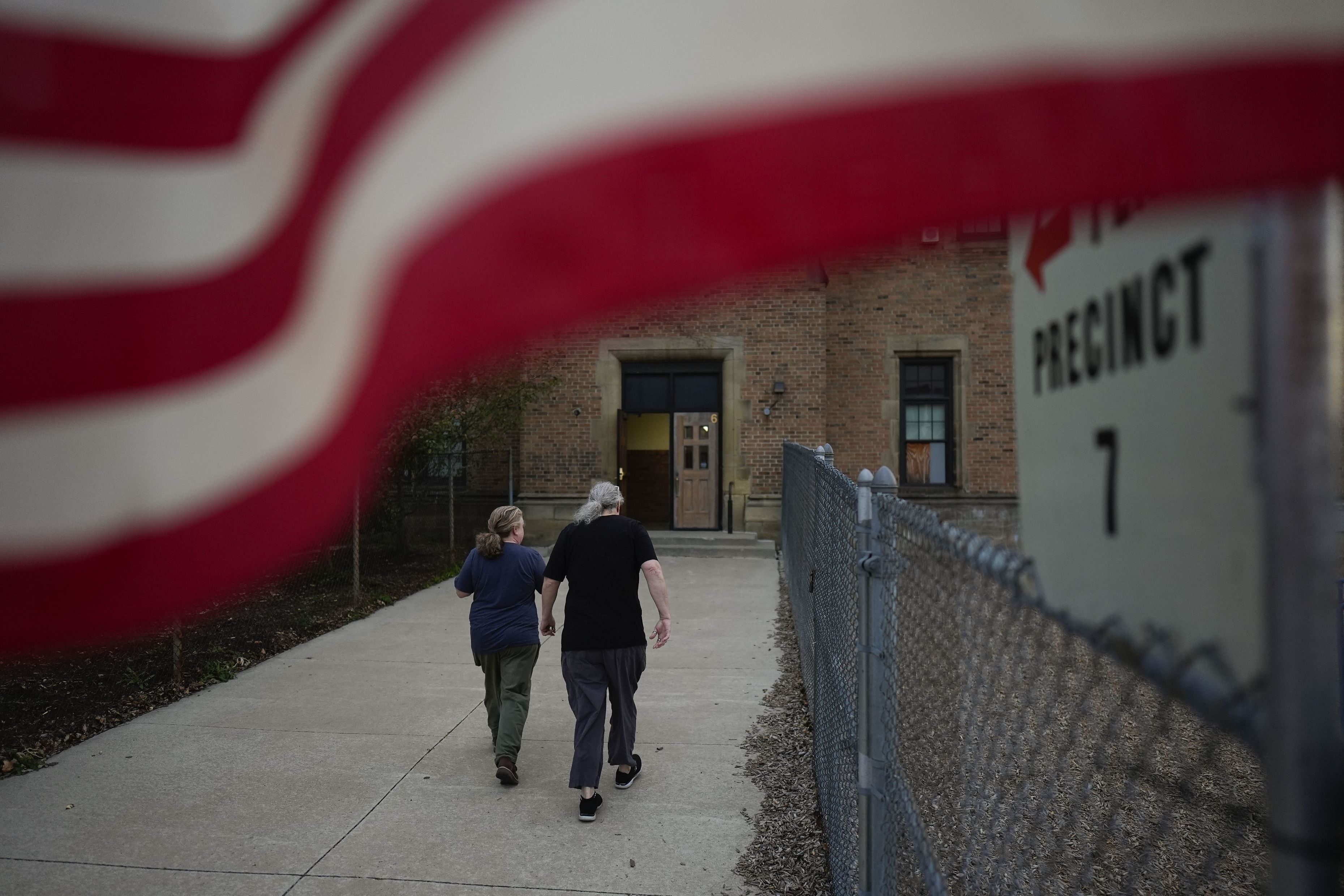 People arrive at a polling place, Tuesday, Nov. 5, 2024, in Dearborn, Mich. (AP Photo/Charlie Neibergall)