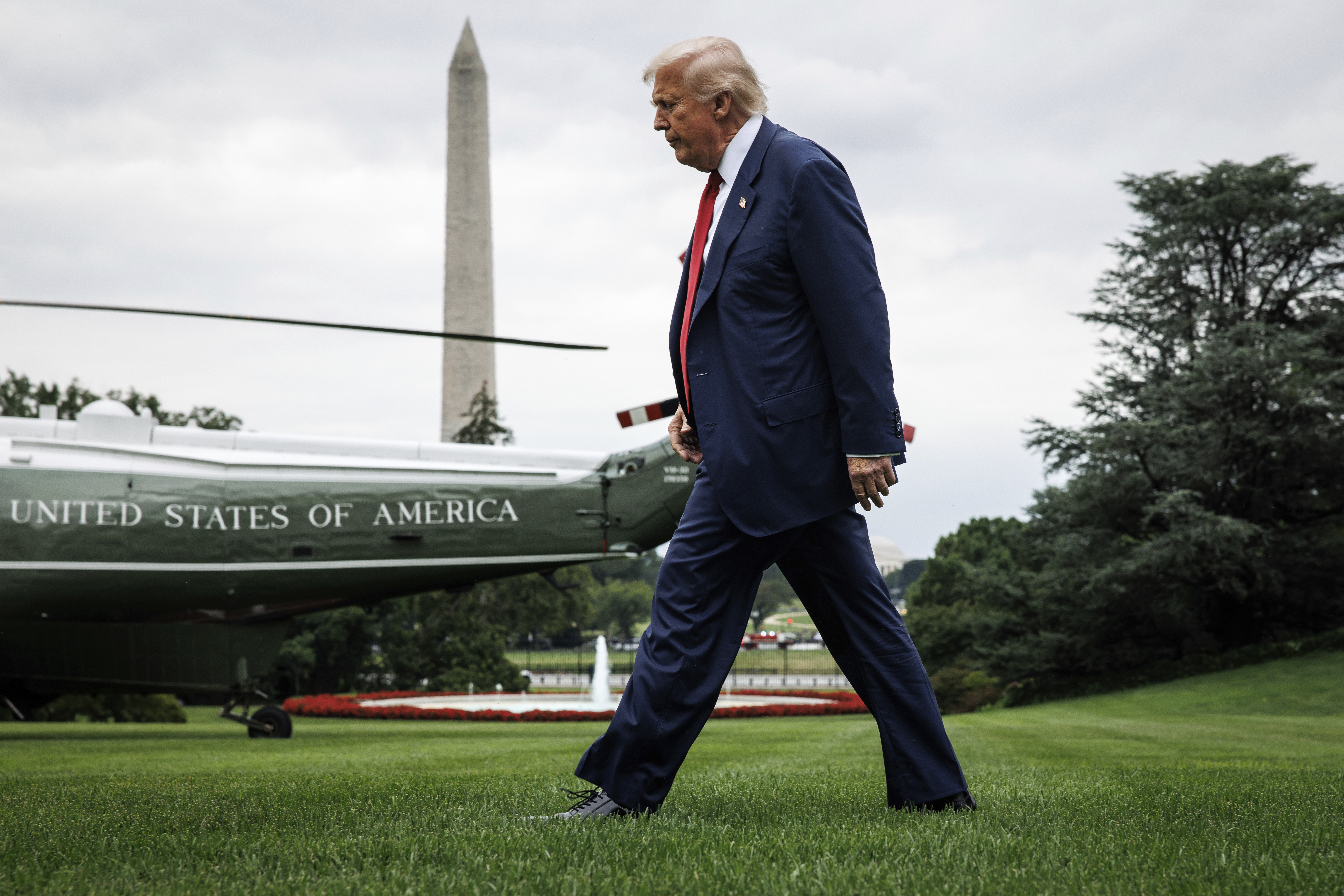 U.S. President Donald Trump walks across the South Lawn after taking questions from reporters before boarding Marine One on August 1, 2025 in Washington, D.C. 