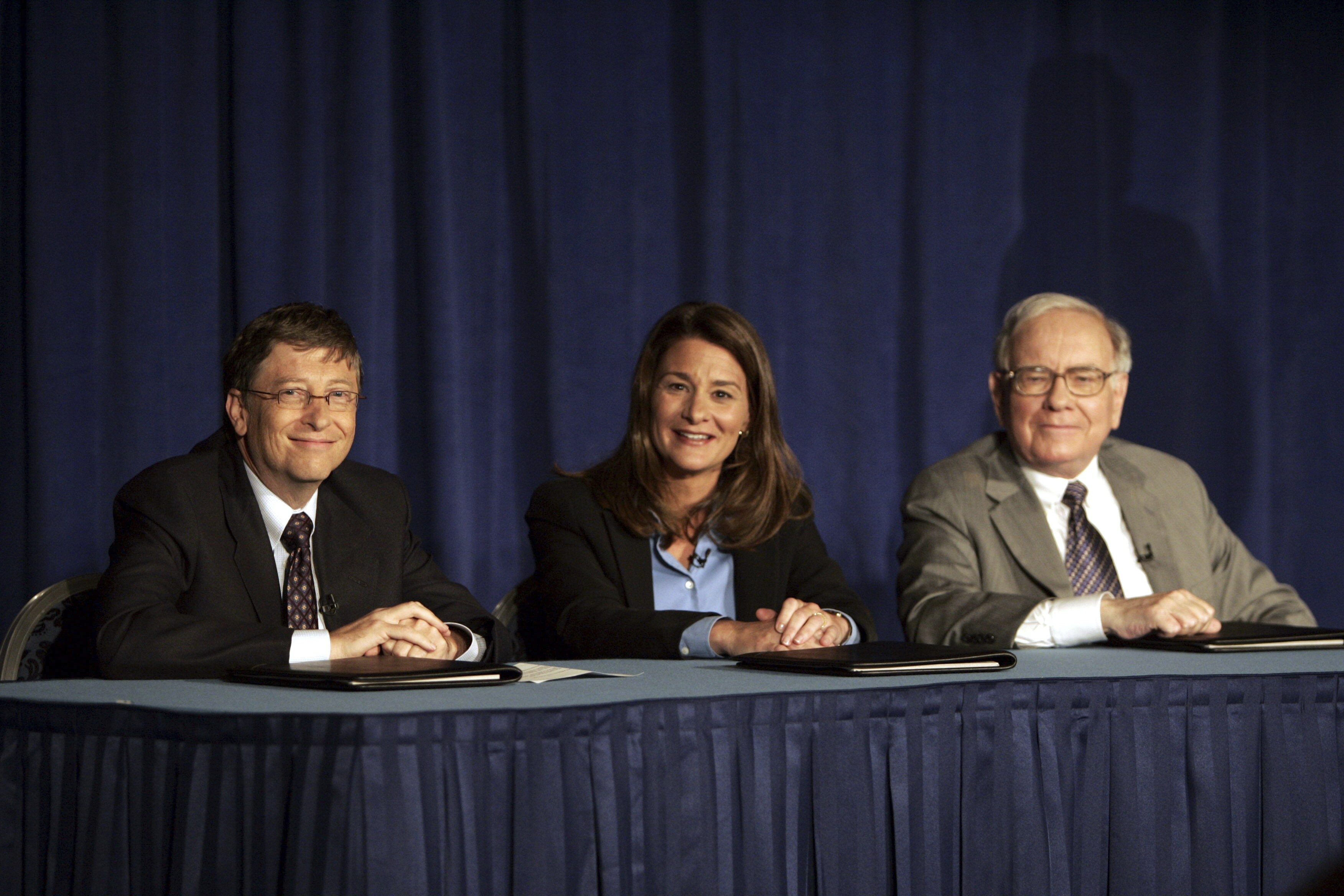 Bill Gates, Melinda Gates and Warren Buffett speak to the media during a press conference, June 26, 2006 in New York.