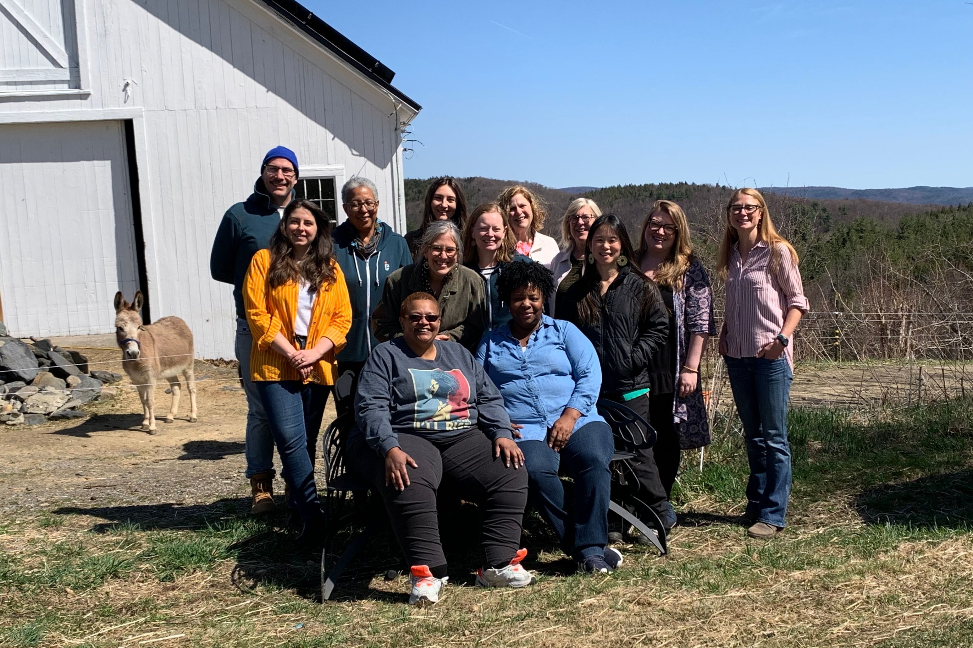 Full Frame Initiative staff pose for a group picture during a final in-person meeting at the farm of executive director Katya Fels Smyth in April 2024 in Mass., shortly before the organization dissolved.