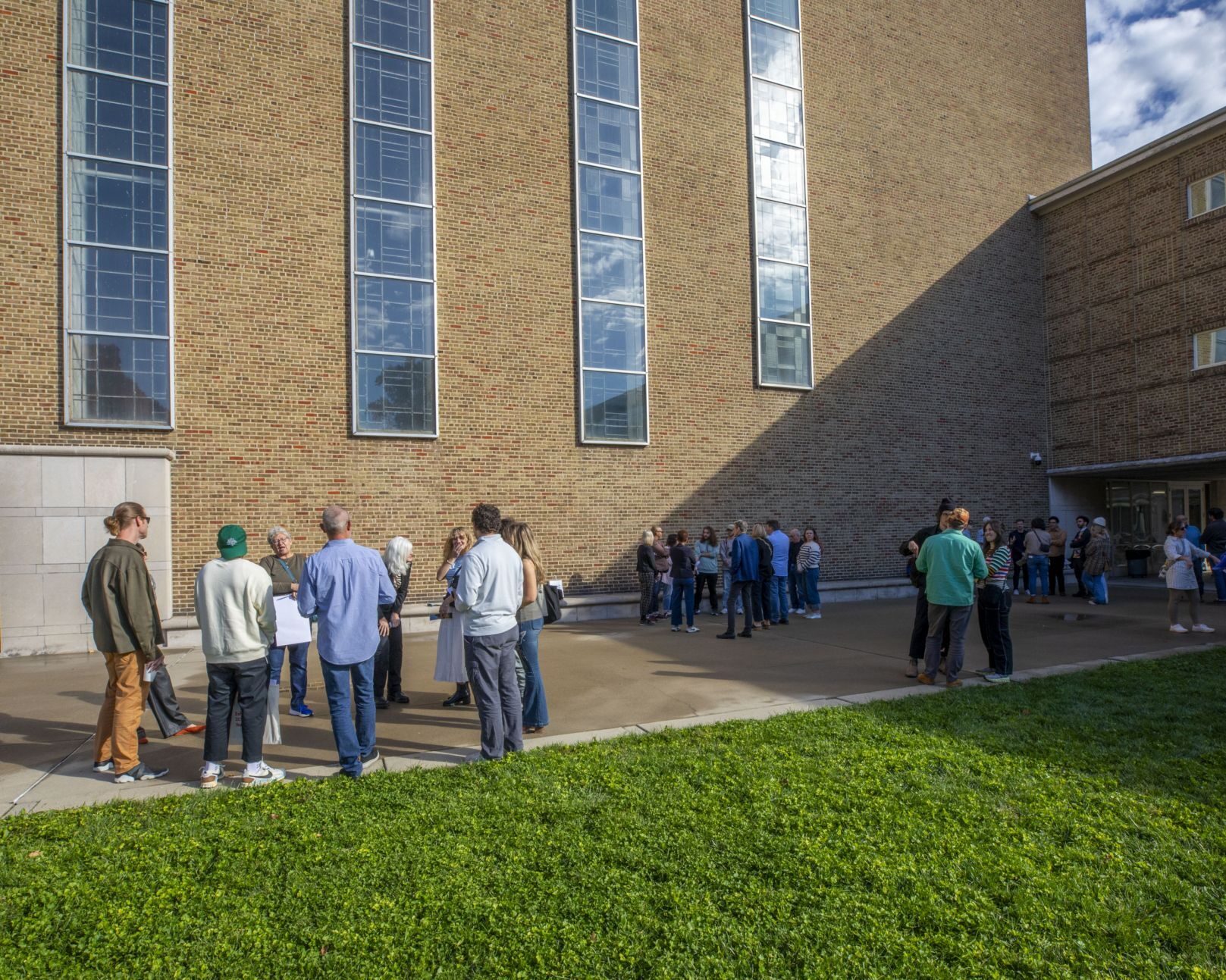 A tour passes through the courtyard at the First Christian Church during the 2024 Exhibit Columbus Symposium.