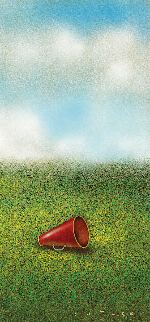 A megaphone lying in grass.
