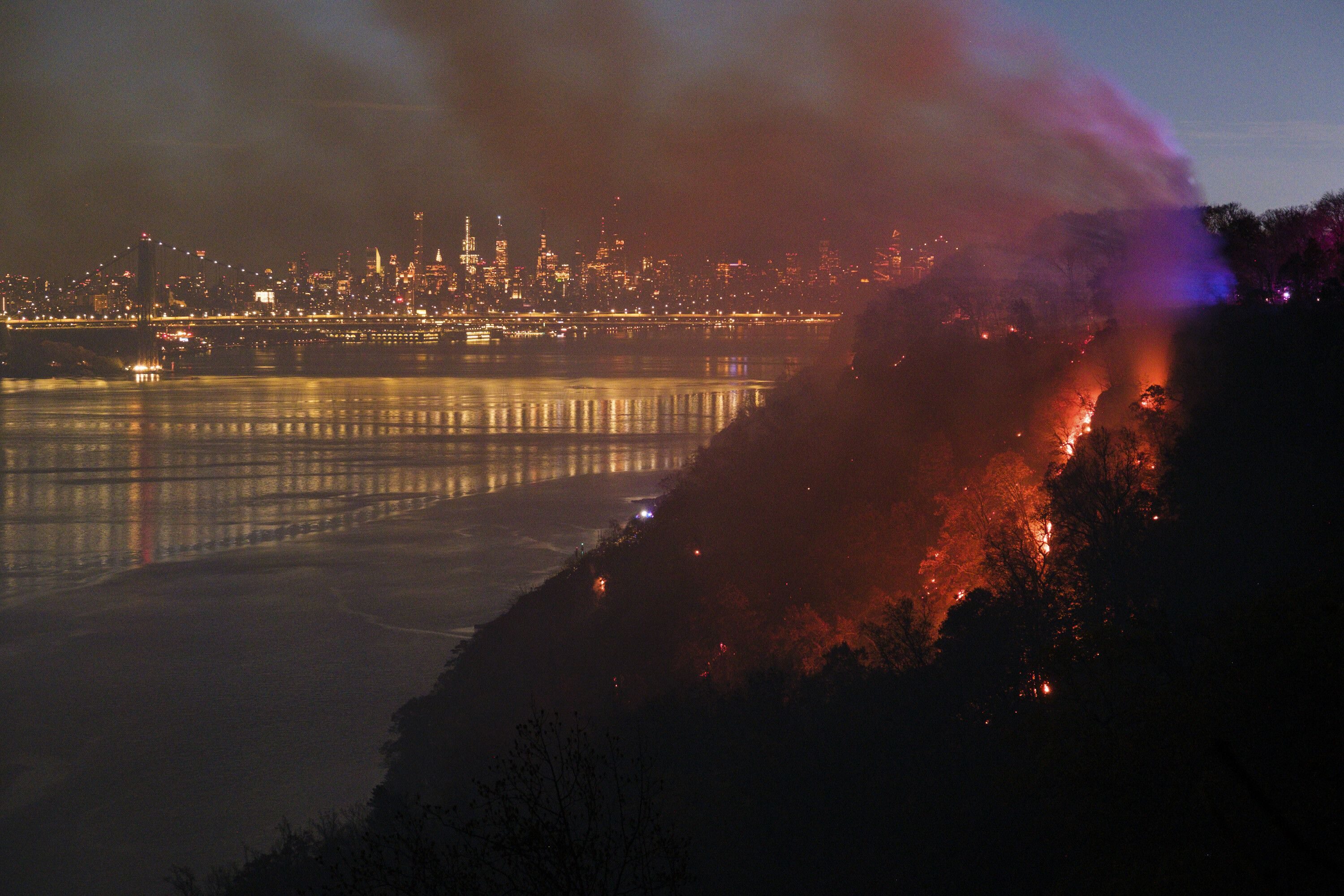 A large brush fire burns in Englewood Cliffs, N.J. on Friday, Nov. 8, 2024. Firefighters in New Jersey and Connecticut have battled hundreds of blazes during an unseasonably dry fall.