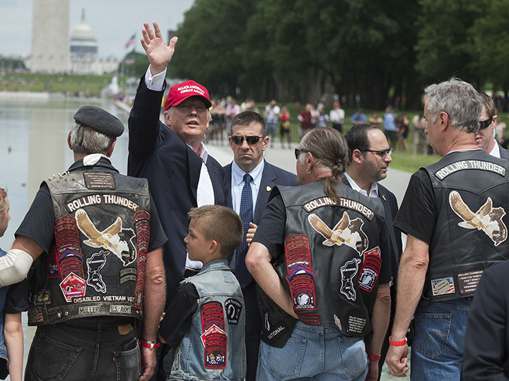 Republican presidential candidate Donald Trump waves to veterans and supporters after an event at the annual Rolling Thunder “Ride for Freedom” parade ahead of Memorial Day.