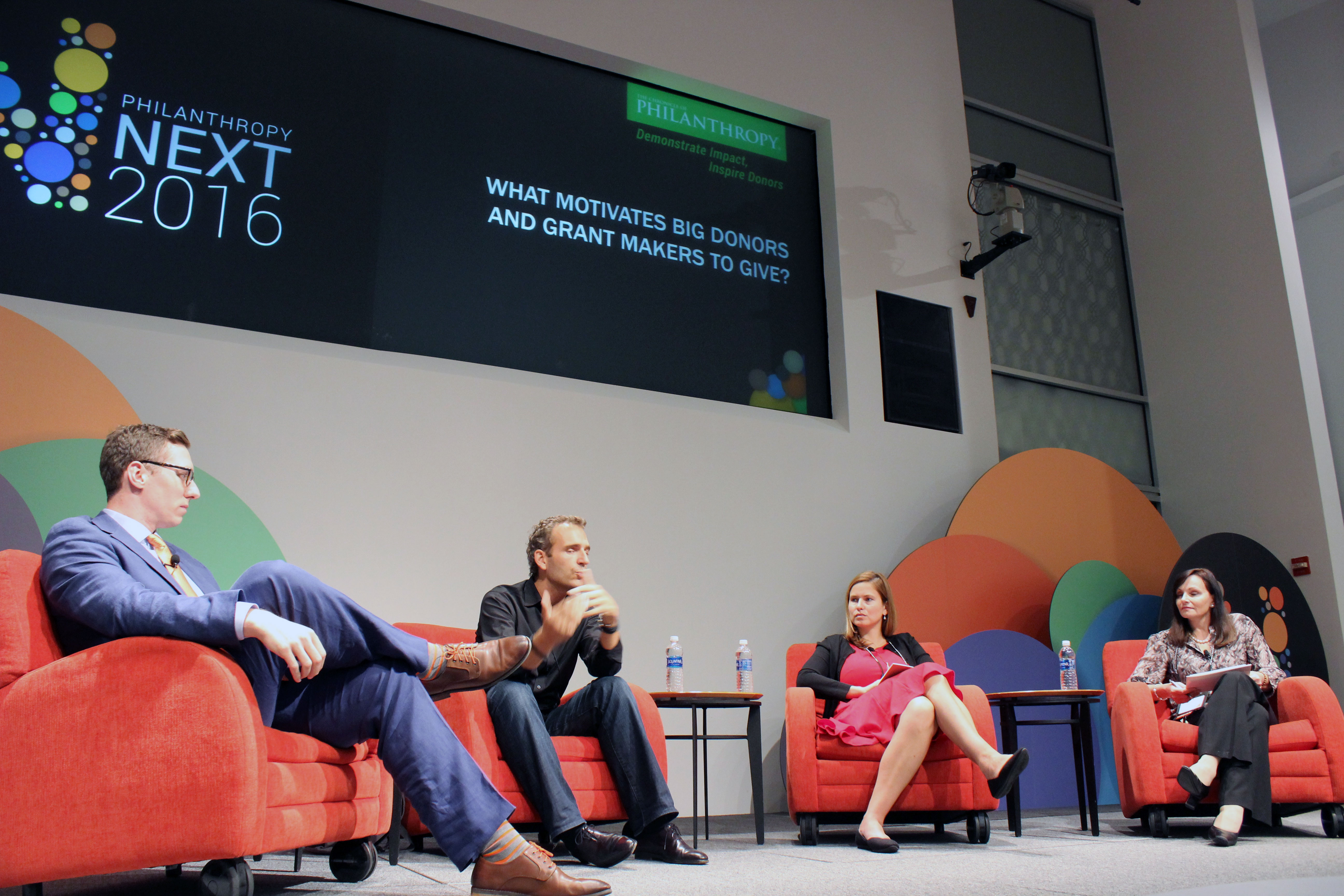 Panelists Alexandre Mars (second from left) of the Epic Foundation, Haviland Rummel of the Susan Crown Exchange, and Gabriela Smith of the Crimsonbridge Group discuss what motivates big donors to give during a session at <em>The Chronicle'</em>s Philanthropy Next conference.