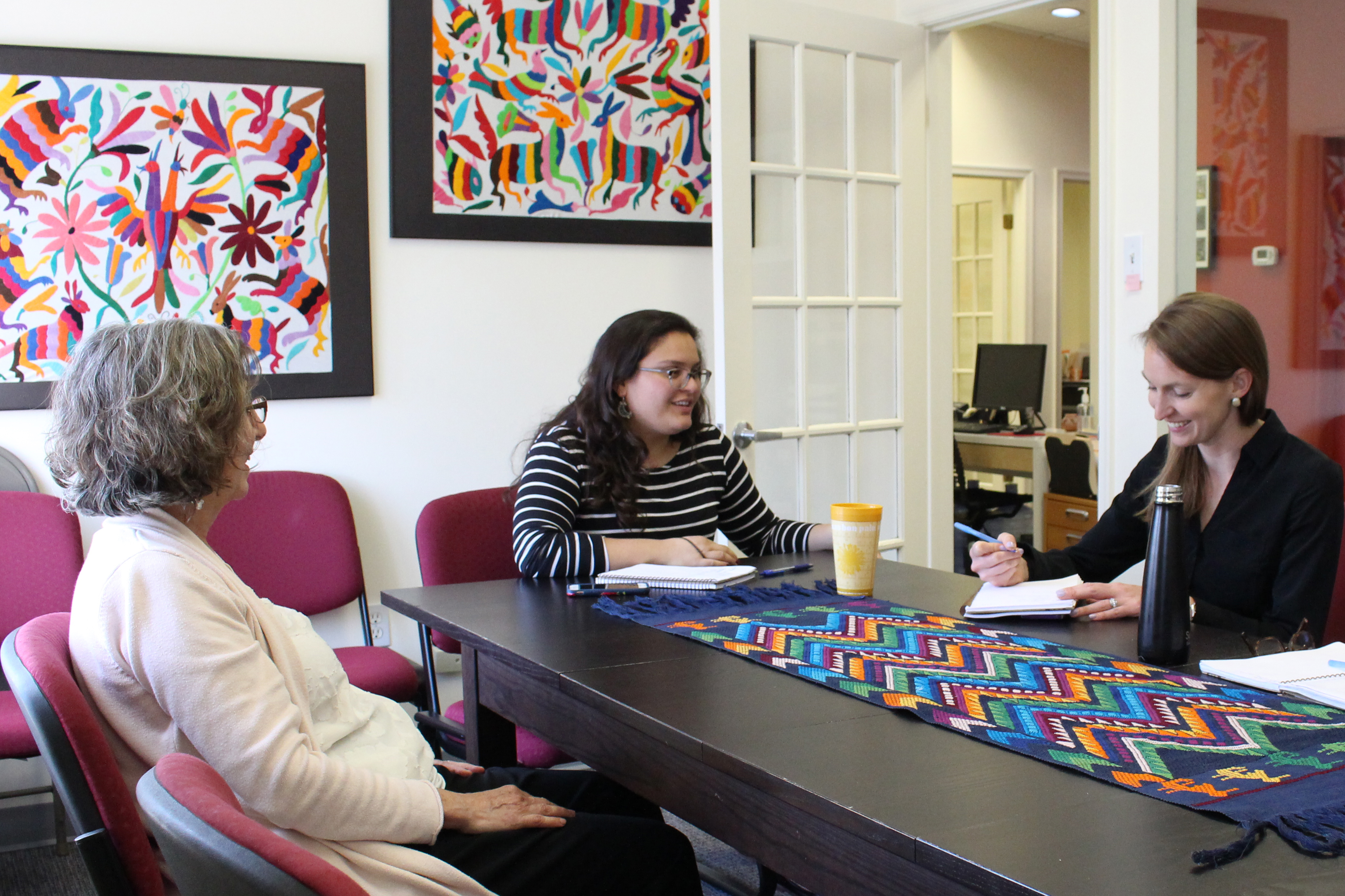 Left to right: Latin America Working Group executive director Lisa Haugaard and program associates Andrea Fernández Aponte and Emma Buckhout work from the third floor of a converted Washington, D.C., townhouse.