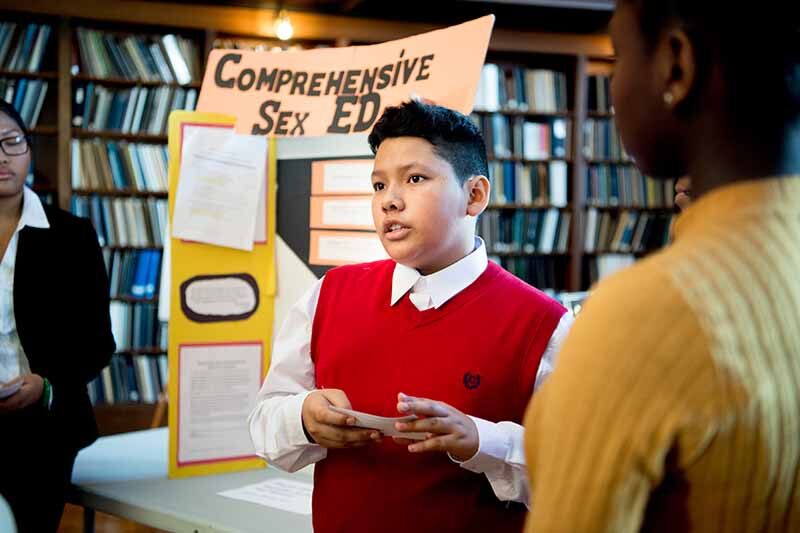 Wilson Hernandez, a Generation Citizen student from Roger Williams Middle School, presents his class project on reducing teen pregnancy rates.