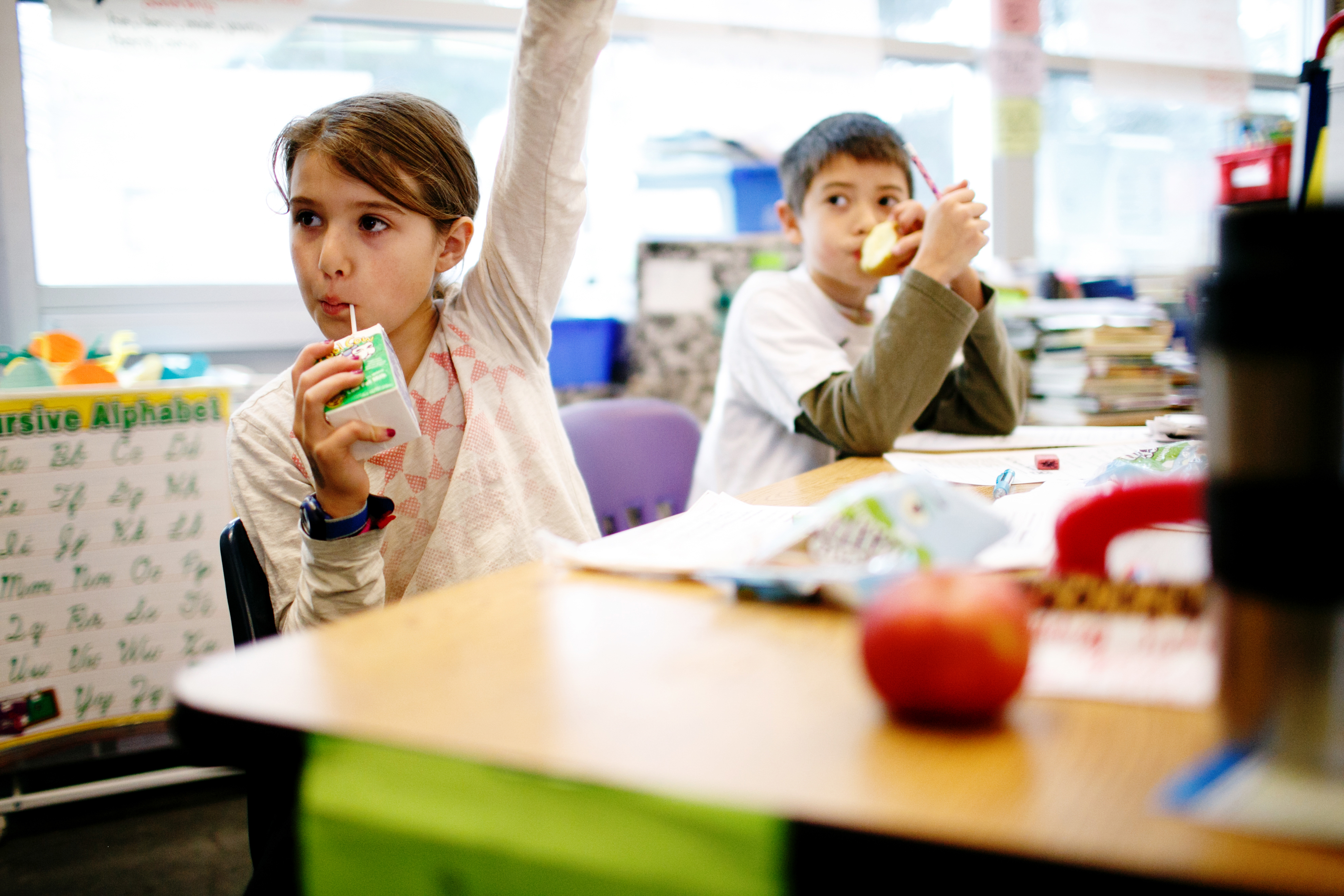 Students in San Francisco interacting with their teacher while having breakfast in their classroom. (No Kid Hungry)