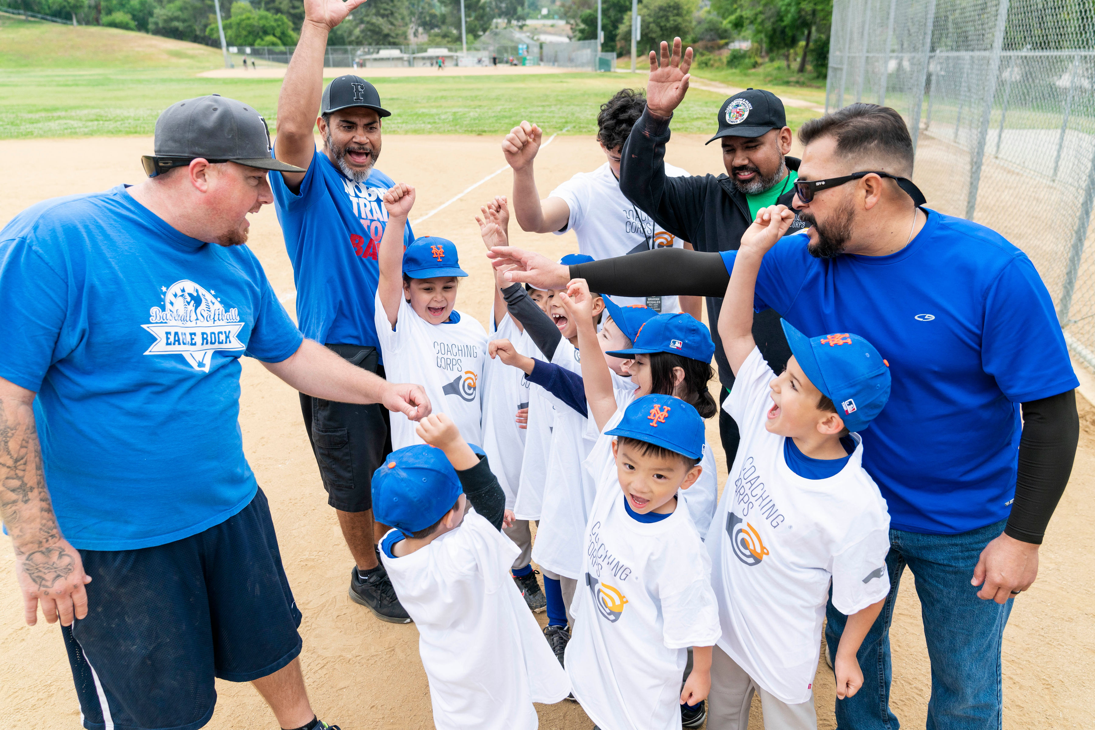 Coaching Corps coaches and team cheer together before taking the field at Eagle Rock Recreation Center in Los Angeles, CA.  (Photo by Victor Cobian)