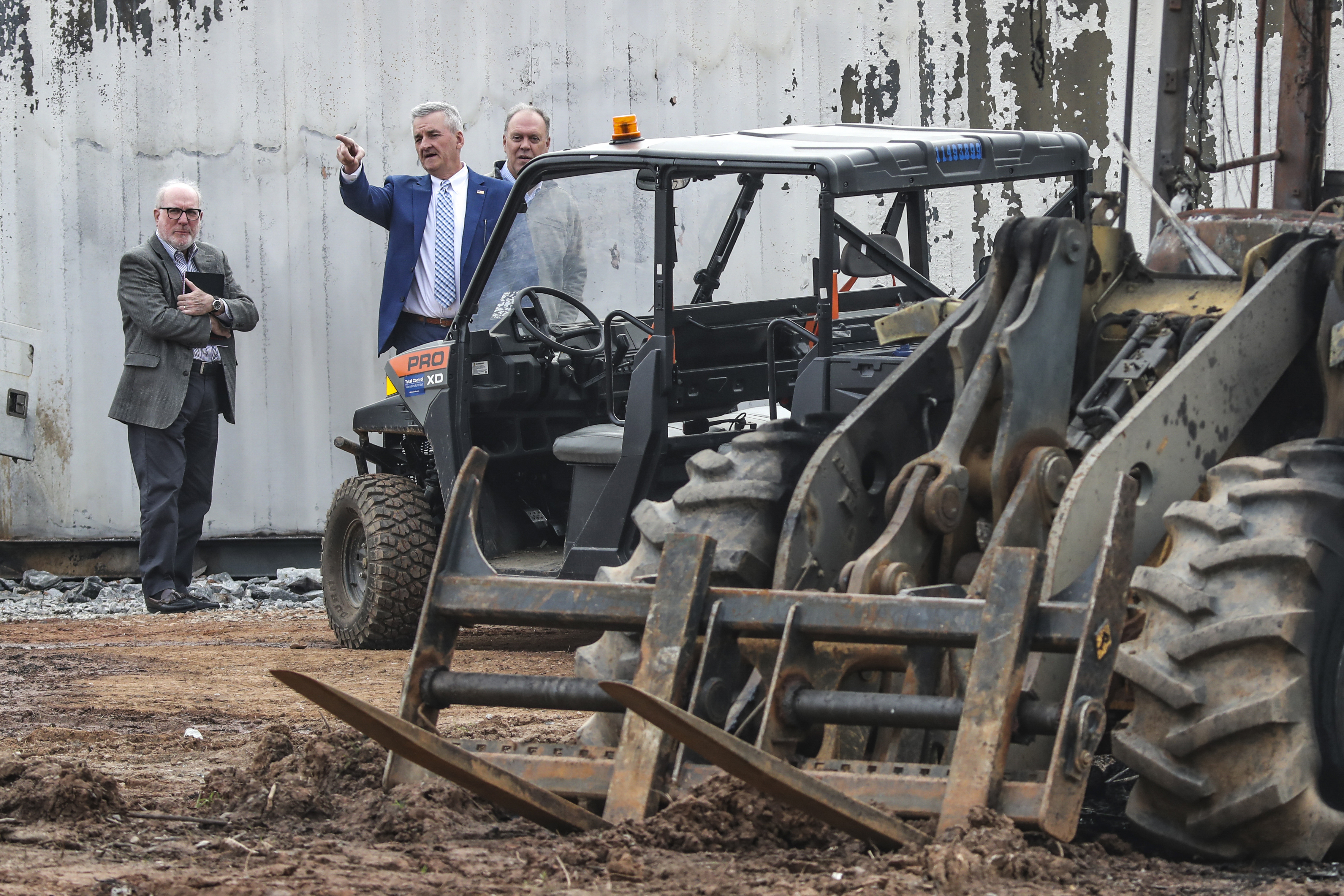 Dave Wilkinson, President and CEO of the Atlanta Police Foundation, center, examines damaged property at the Atlanta Public Safety Training Center in DeKalb County, Ga., Monday, March 6, 2023. More than 20 people from around the country faced domestic terrorism charges Monday after dozens of young men in black masks attacked the site of a police training center under construction in a wooded area outside Atlanta where one protester was killed in January. 