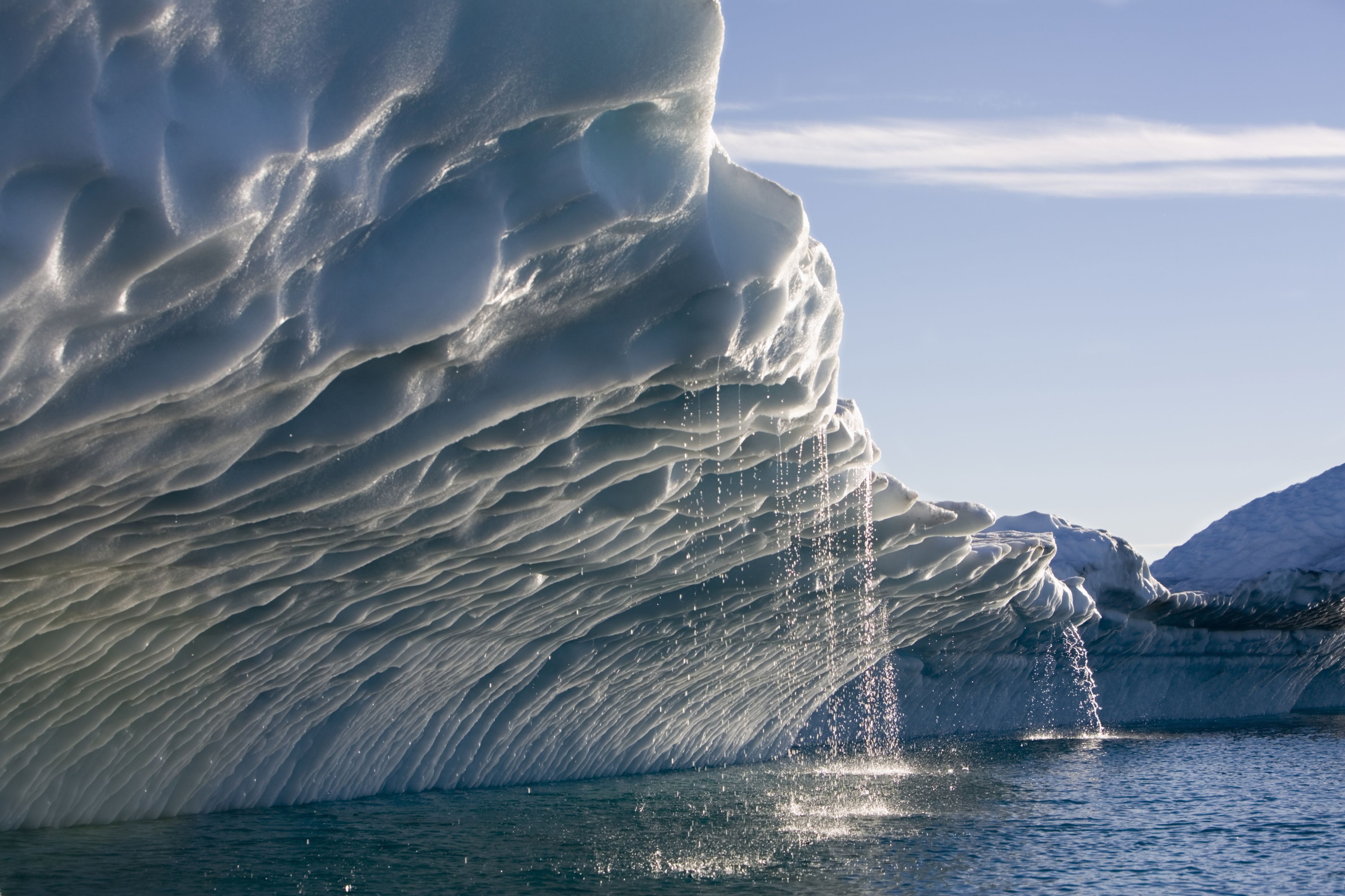 Melting water streams from iceberg calved from Ilulissat Kangerlua Glacier (Jakobshavn Icefjord) in Disko Bay.