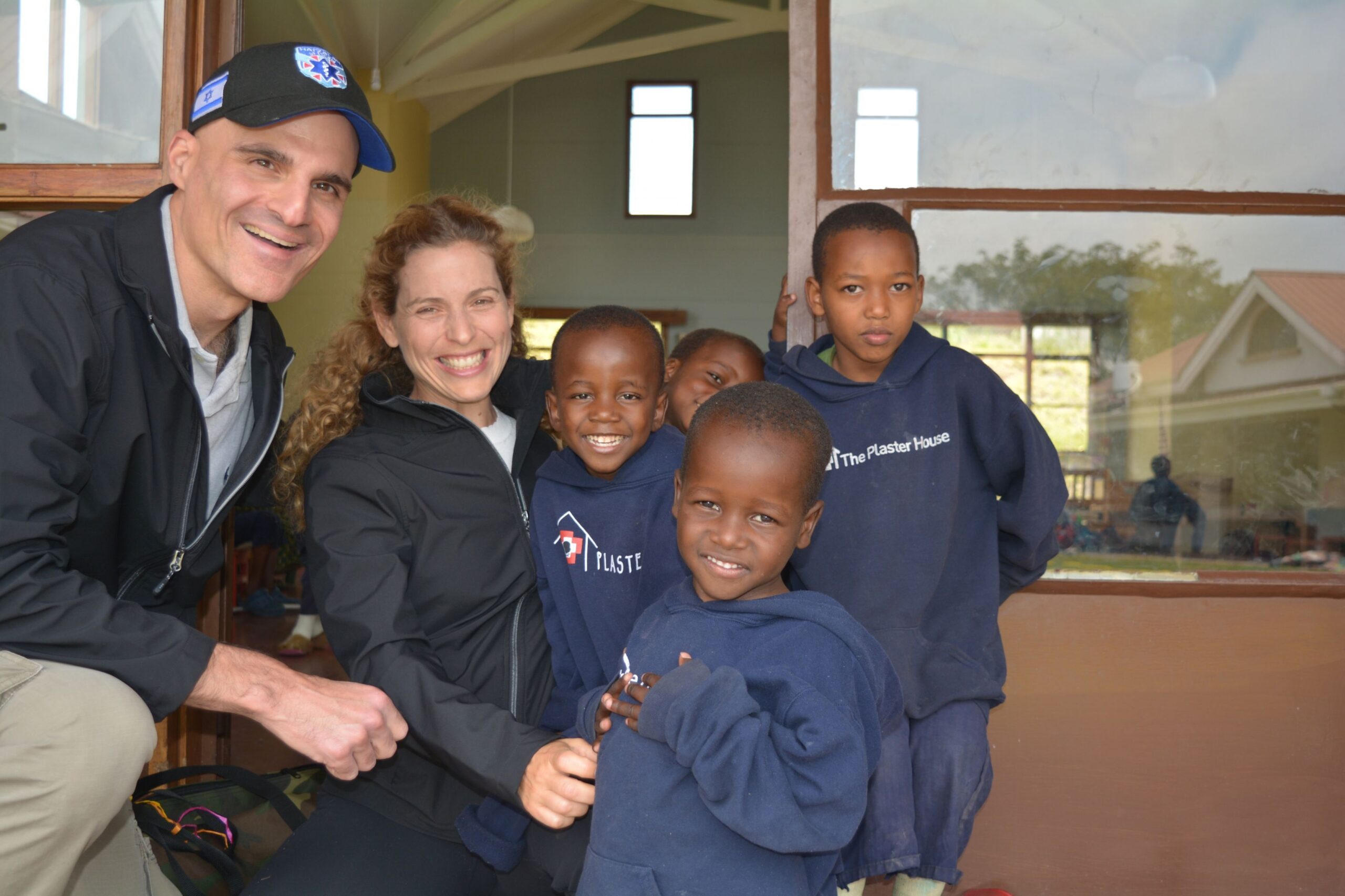Mark and Erica Gerson with children receiving care at the Plaster House, Arusha, Tanzania, on a trip with African Mission Healthcare.