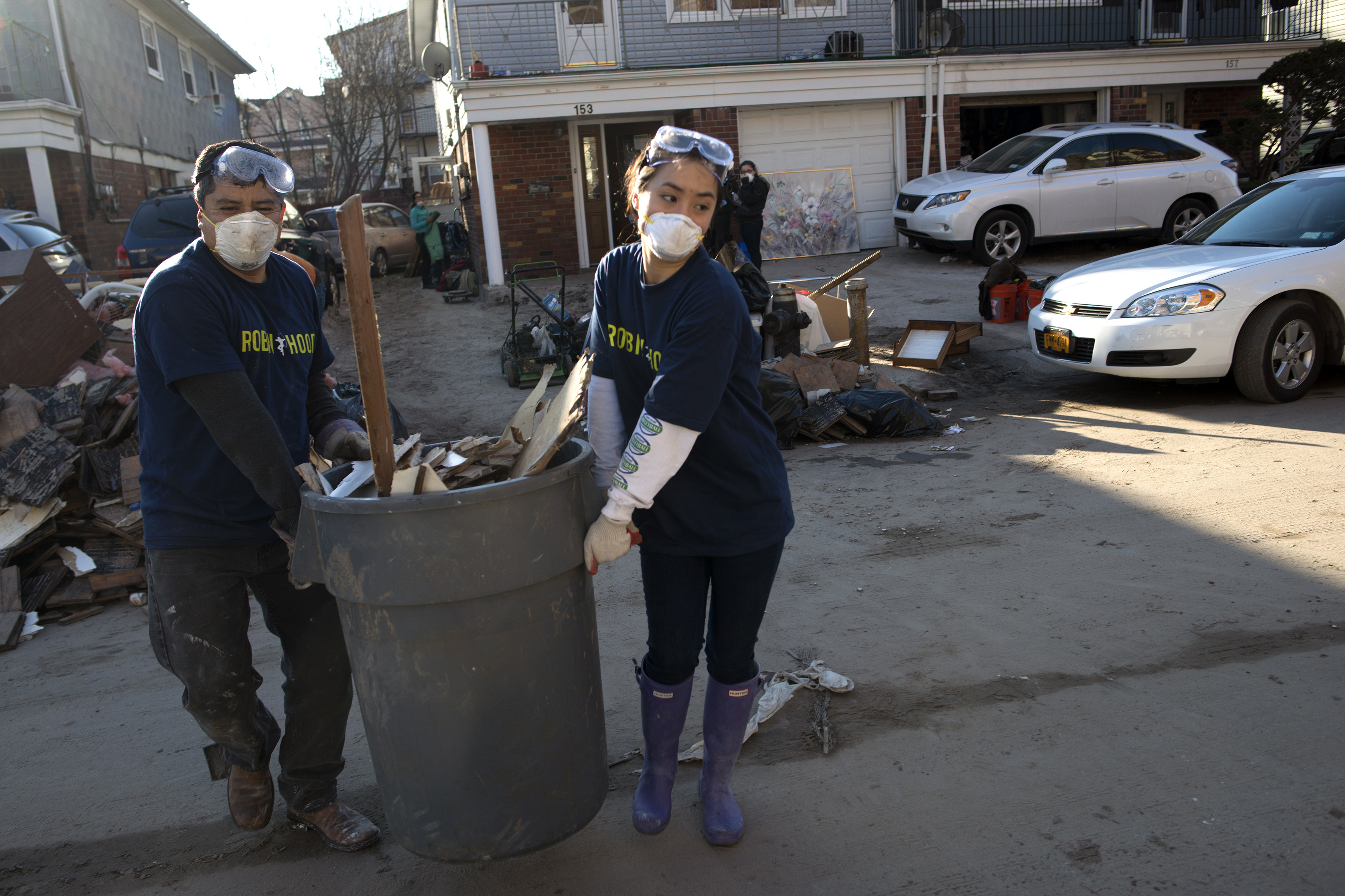 Photo of volunteers picking up debris after Hurricane Sandy