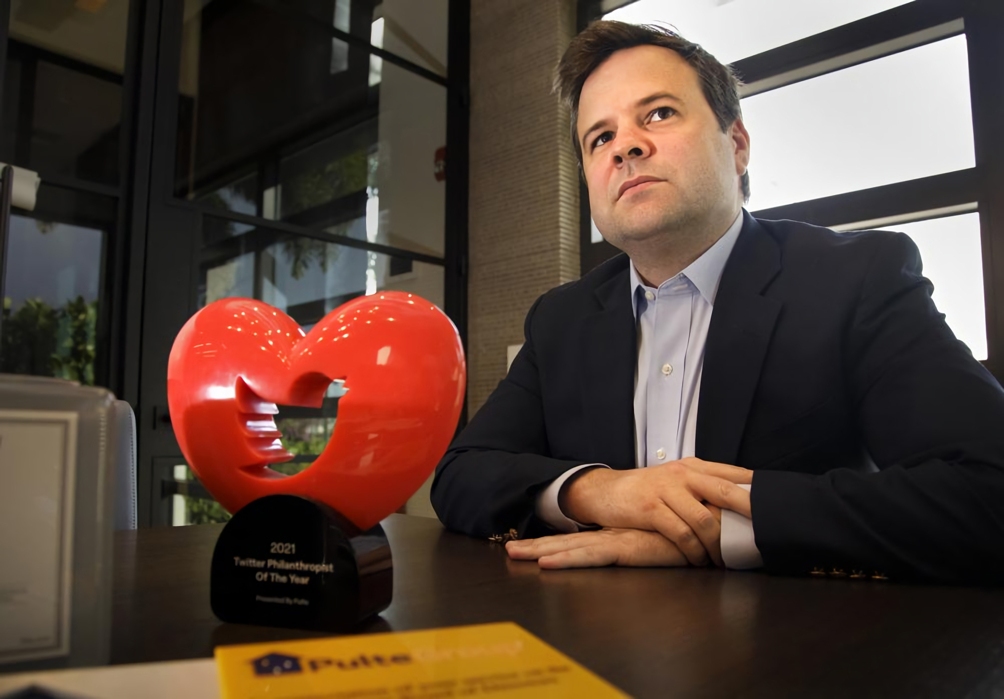 Bill Pulte with the Twitter Philanthropist of the Year trophy as he is interviewed in his offices in Boca Raton, Florida Monday, Dec. 13, 2021. Pulte has spearheaded “Twitter philanthropy” – an approach to direct giving in which Pulte and others offer immediate financial support to people who reach out every day over social media.