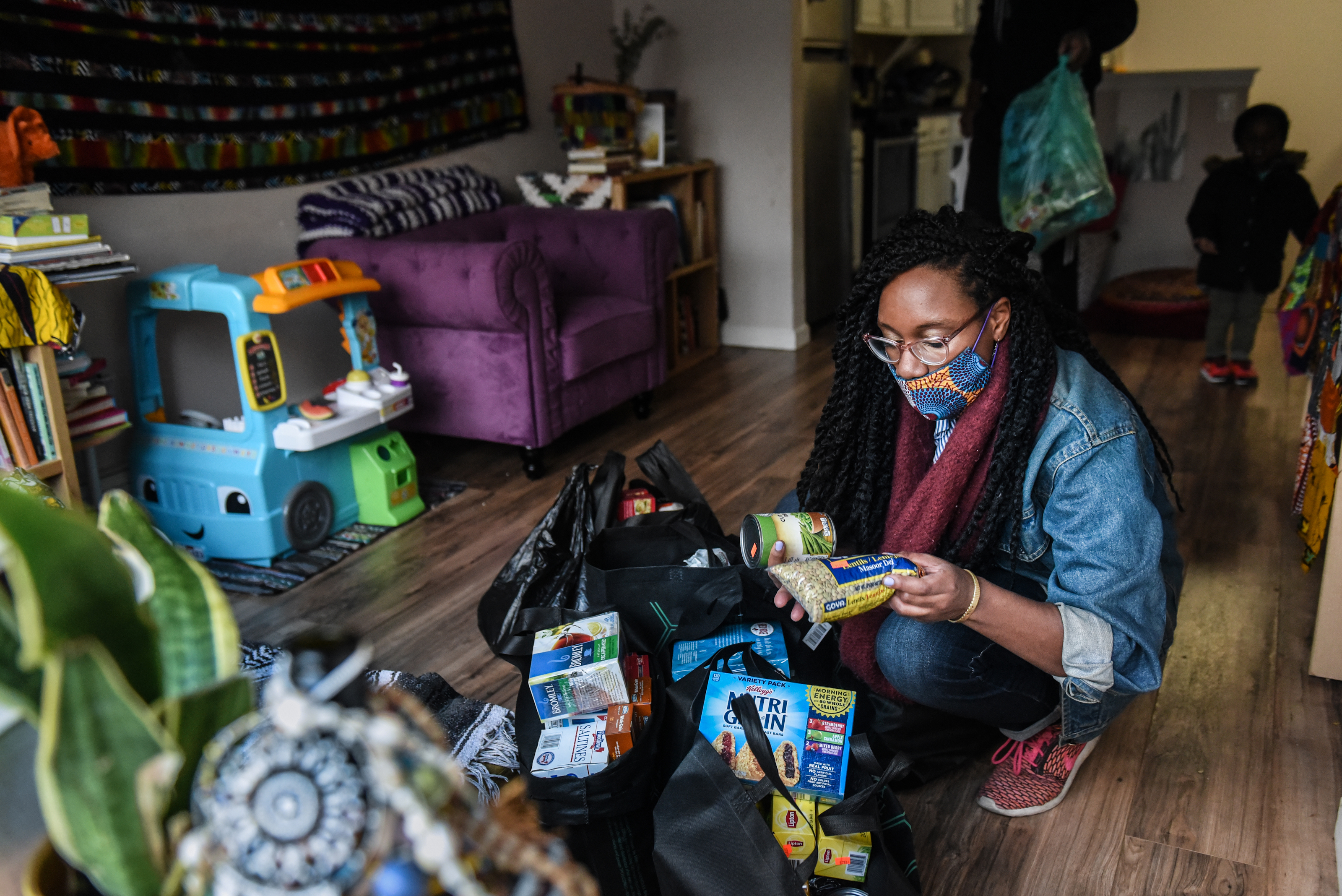 Sevonna Brown of Black Women’s Blueprint looks at food and essential items that were delivered to her on May 11, 2020 in the Bedford-Stuyvesant neighborhood in the Brooklyn borough in New York City. Neighborhood mutual aid groups have been cropping up across New York City in an effort to address the economic impact of eight weeks of economic lockdown and the resulting loss of income. Mutual aid provides free food and essential items to communities most in need. Black Woman’s Blueprint runs a van called Sistas Van that visits low-income communities of color.