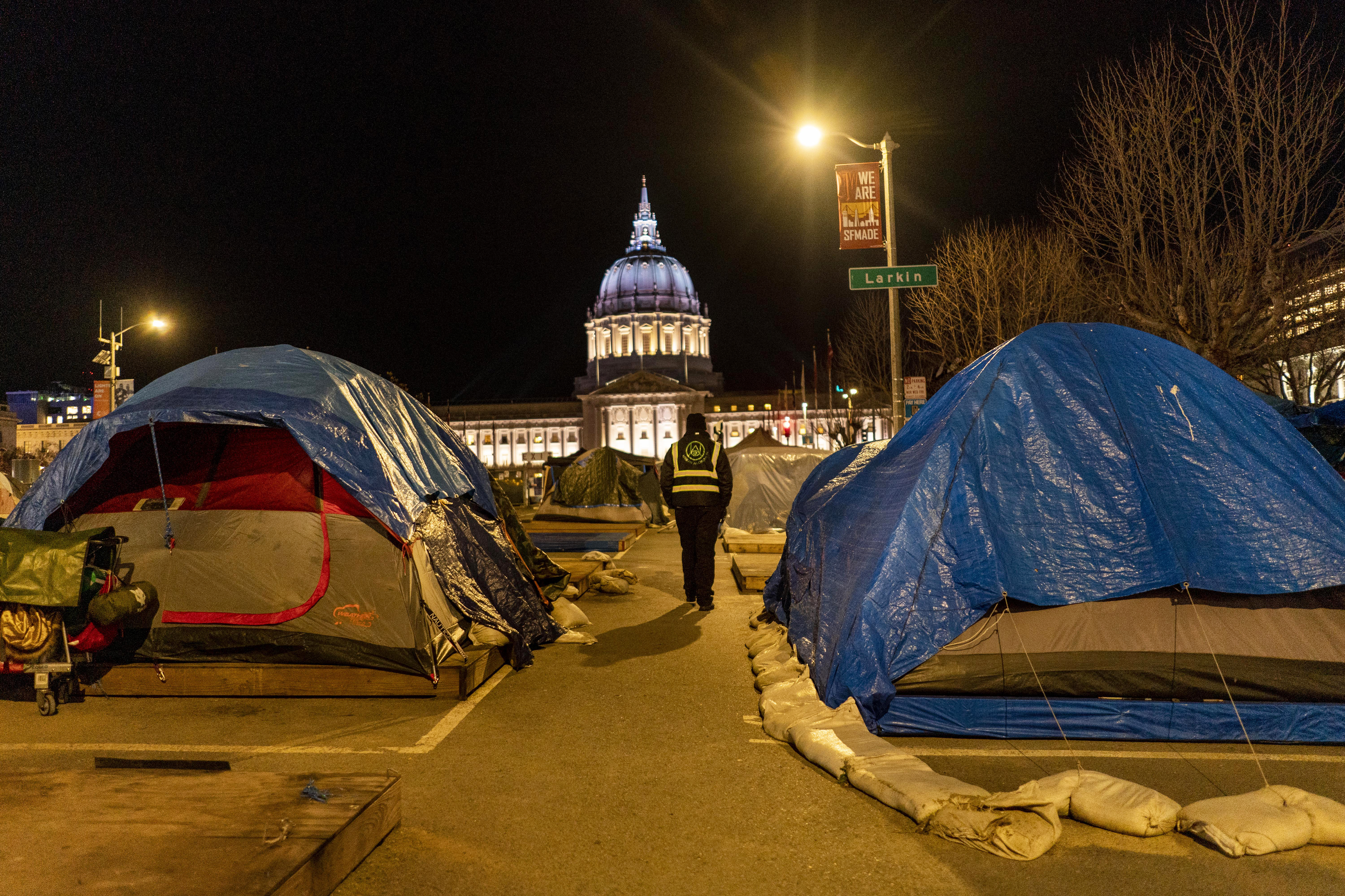 Urban Alchemy’s Rodney Wrice patrols a homeless tent village a block away from San Franciscos City Hall in the Tenderloin neighborhood of San Francisco, California Thursday January 27, 2022.  Mayor London Breeds efforts to cleanup the Tenderloin neighborhood over the past two years has increased in effort with a her recent State of Emergency.