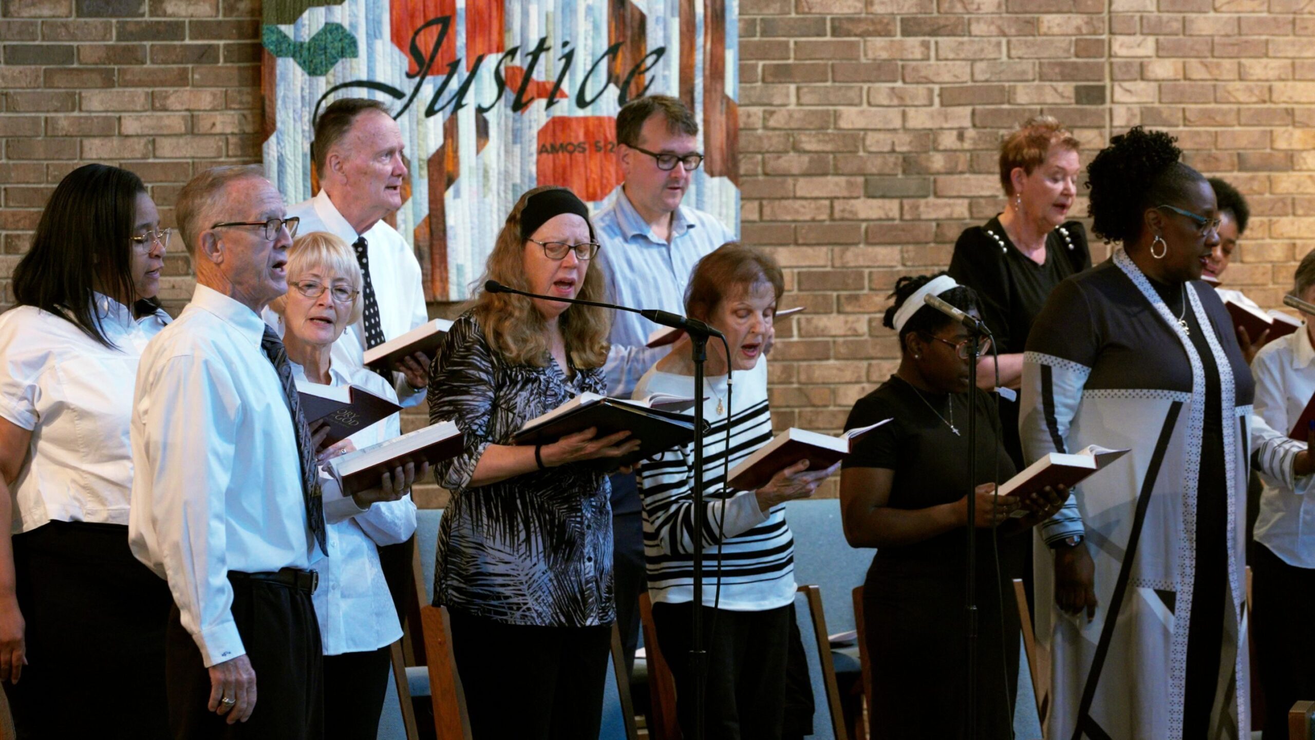 Choir members from both Hope Presbyterian and Bethel New Life churches sing together during a joint service on World Communion Sunday.