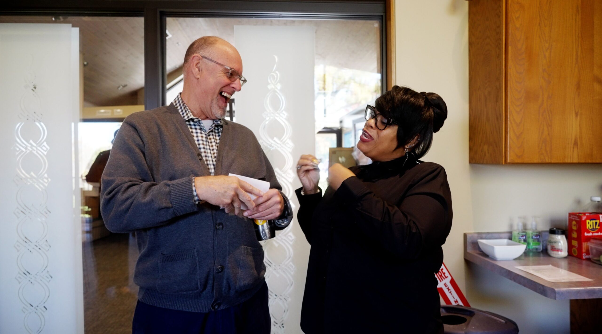 Jacquetta Carter jokes with Tom Schmidt of Hope Presbyterian between Hope Presbyterian and Bethel New Life services, at Hope Presbyterian church in Wheaton, Illinois.
