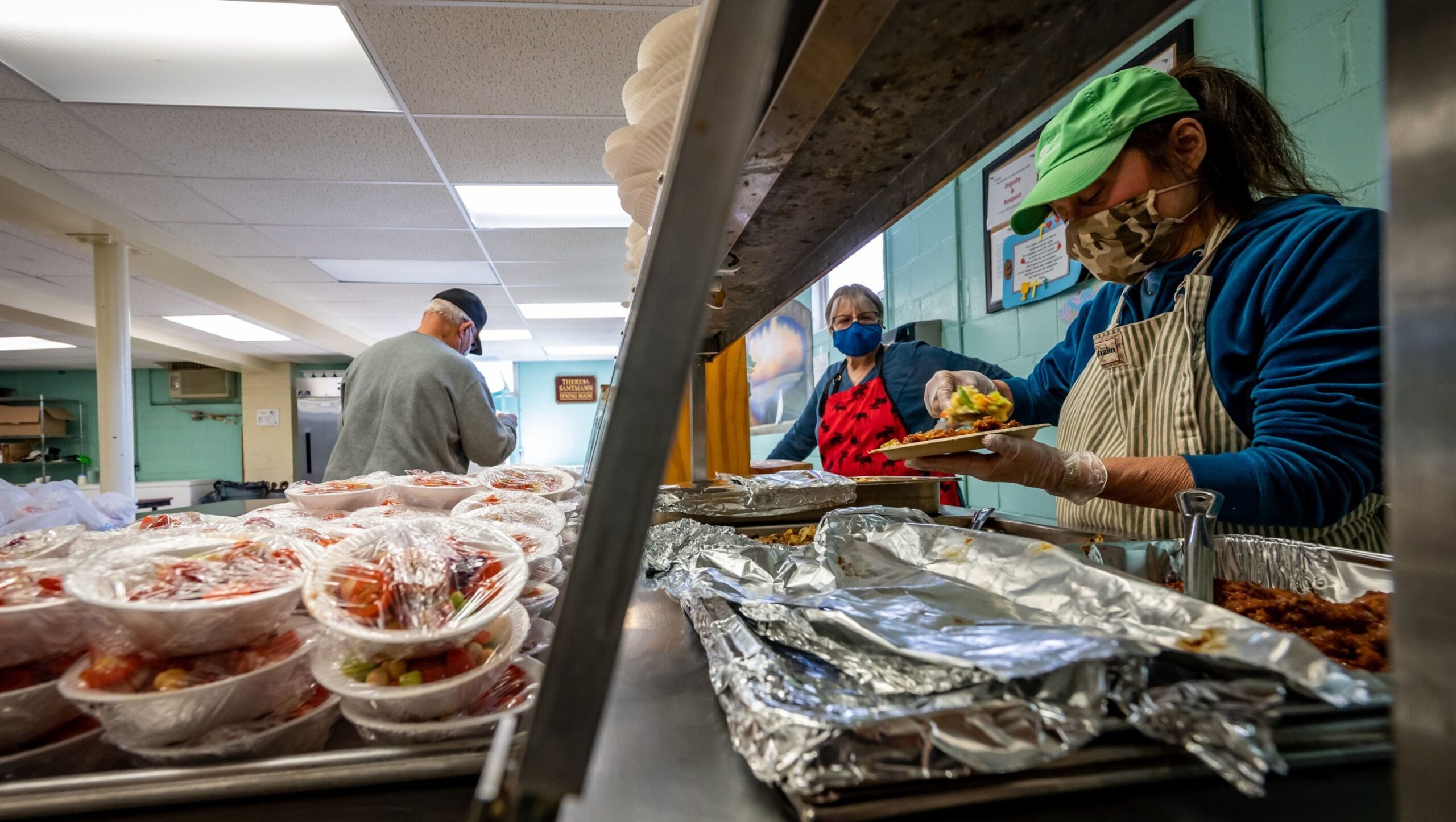 At the Trinity Evangelical Lutheran Church in Wyandanch, New York, volunteers prepare hot meals in the soup kitchen on December 22, 2021.